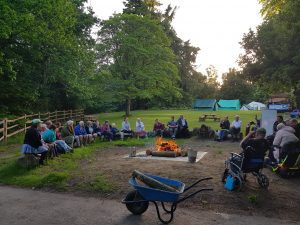 Campers round the camp fire.